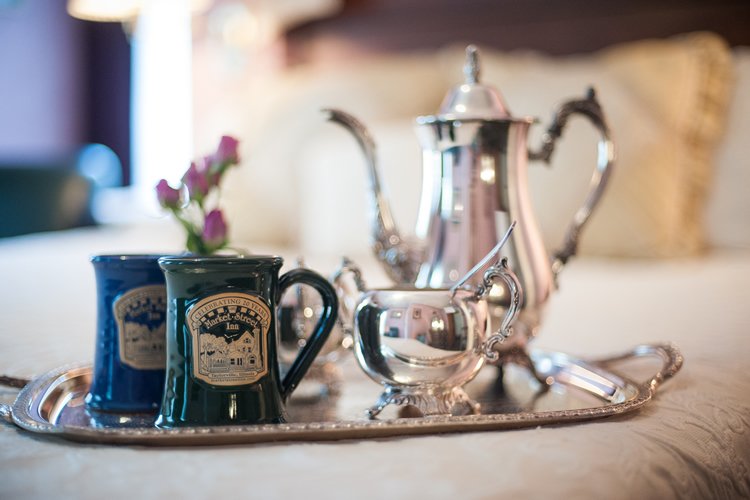 two mugs and silver coffee pot