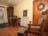 Sitting area, hardwood floors table and chairs with laptop, and old fashion wood chair with ottoman