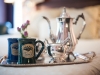 two mugs and silver coffee pot