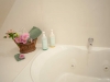 Jetted tub with a basket with pink flowers